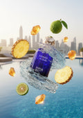 Blue perfume bottle labeled 'Summer in Dubai' by ANFAR with floating fruits on a cityscape background.