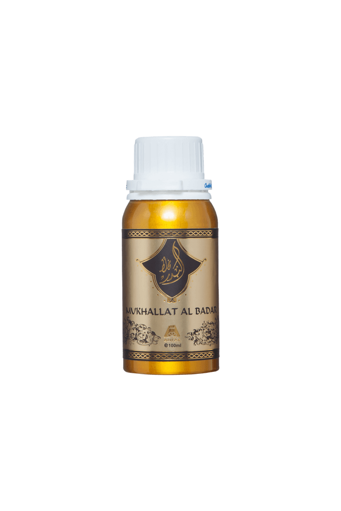 A bottle of Mukhallat Al Badar perfume with a beige label and a white cap.